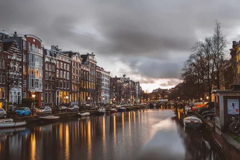 Amsterdam canal lined with historic houses at dusk